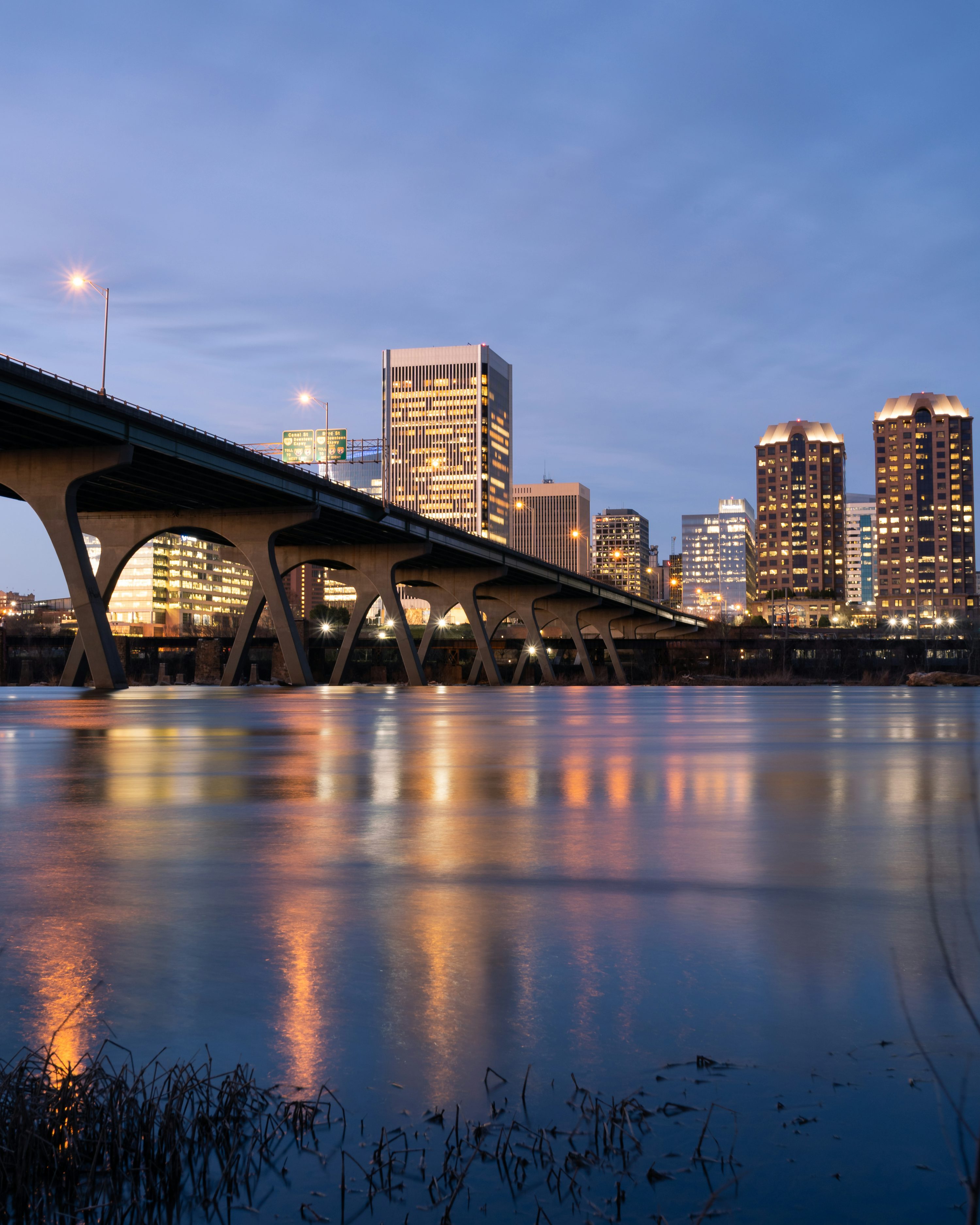 Manchester Bridge and the Richmond skyline reflected in the James River at dusk